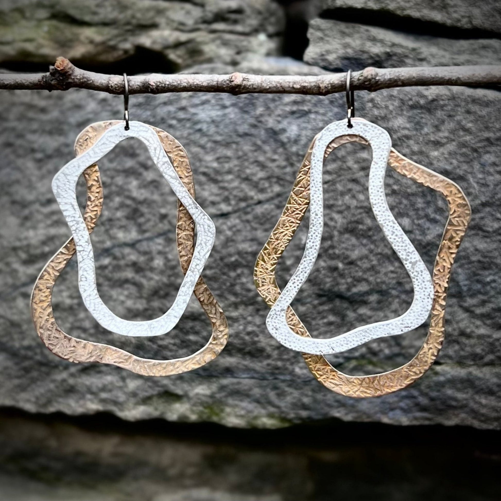 These gorgeous, handcrafted Canyon Earrings, feature overlapping, textured bronze and sterling silver pieces. The asymmetrical pair are striking, comfortable and have beautiful movement. These unique pieces are made to order and can take up to one week to ship. Clean regularly with polishing pad or soft cloth and mild soap. Consciously made in New York.