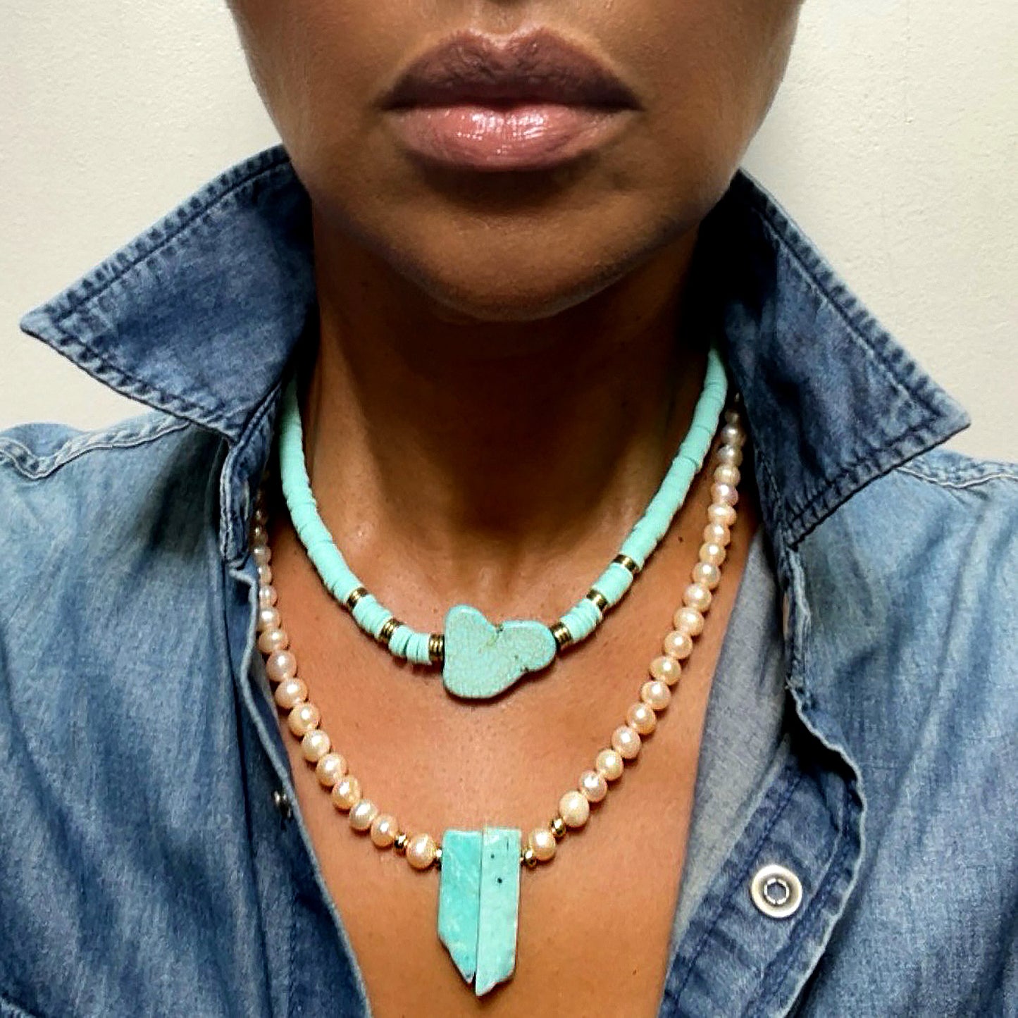 Fresh water, champagne pearl necklace with gold filled beads and Amazonite pendant. Pearls promote purity, faith, loyalty and truth, and is the birthstone of the astrological sign Gemini. Amazonite, known for creativity, goal setting and truth, is a must for artists, teachers, and anyone who leans into their creative side. A show stopper on it's own, or layer it for more gorgeousness. Dimensions: 19.5 inches, Pearls: 5/6mm, Amazonite: 1 inch Consciously made in California