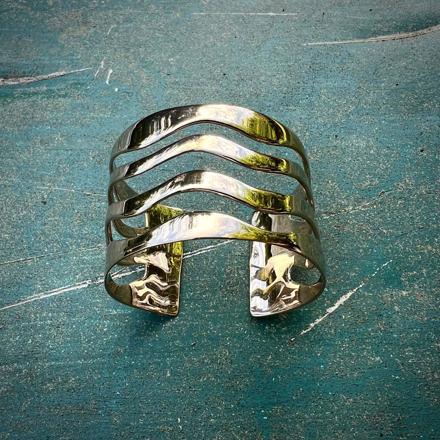 The Sea Cuff is bold, weighty, and makes a statement. Crafted from 16-gauge metal in sterling silver or bronze, its design evokes the beauty of ocean waves. This classic piece is the perfect complement to any jewelry collection. Clean with polishing pad or soft cloth and mild soap. Consciously made in New York.