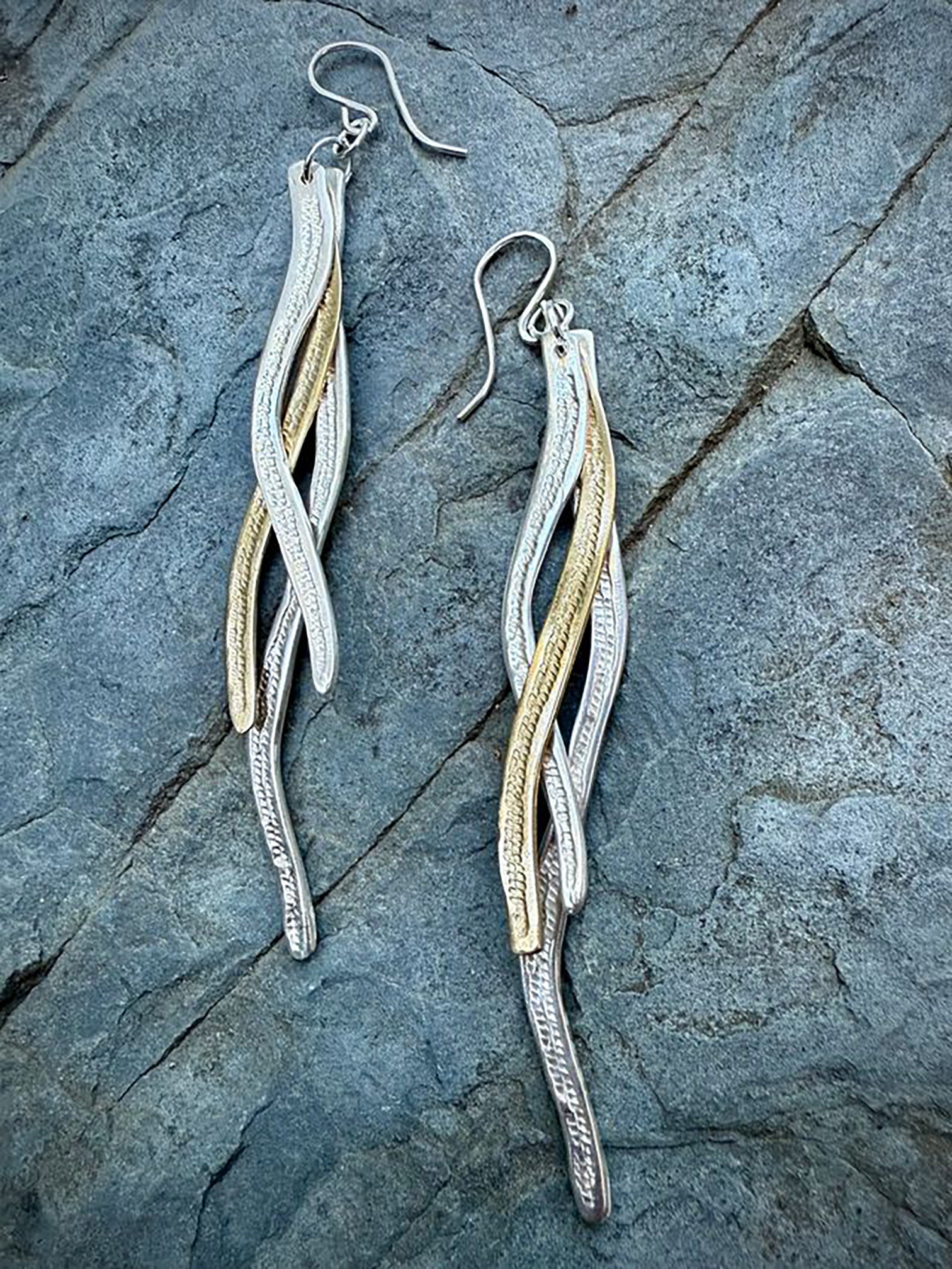 These mixed-metal earrings are made with gently curved sterling silver and brass. Each individual piece has been carefully hand texturized and shaped to create a stunning overlapping effect. The earrings are lightweight, vibrant and have beautiful movement.