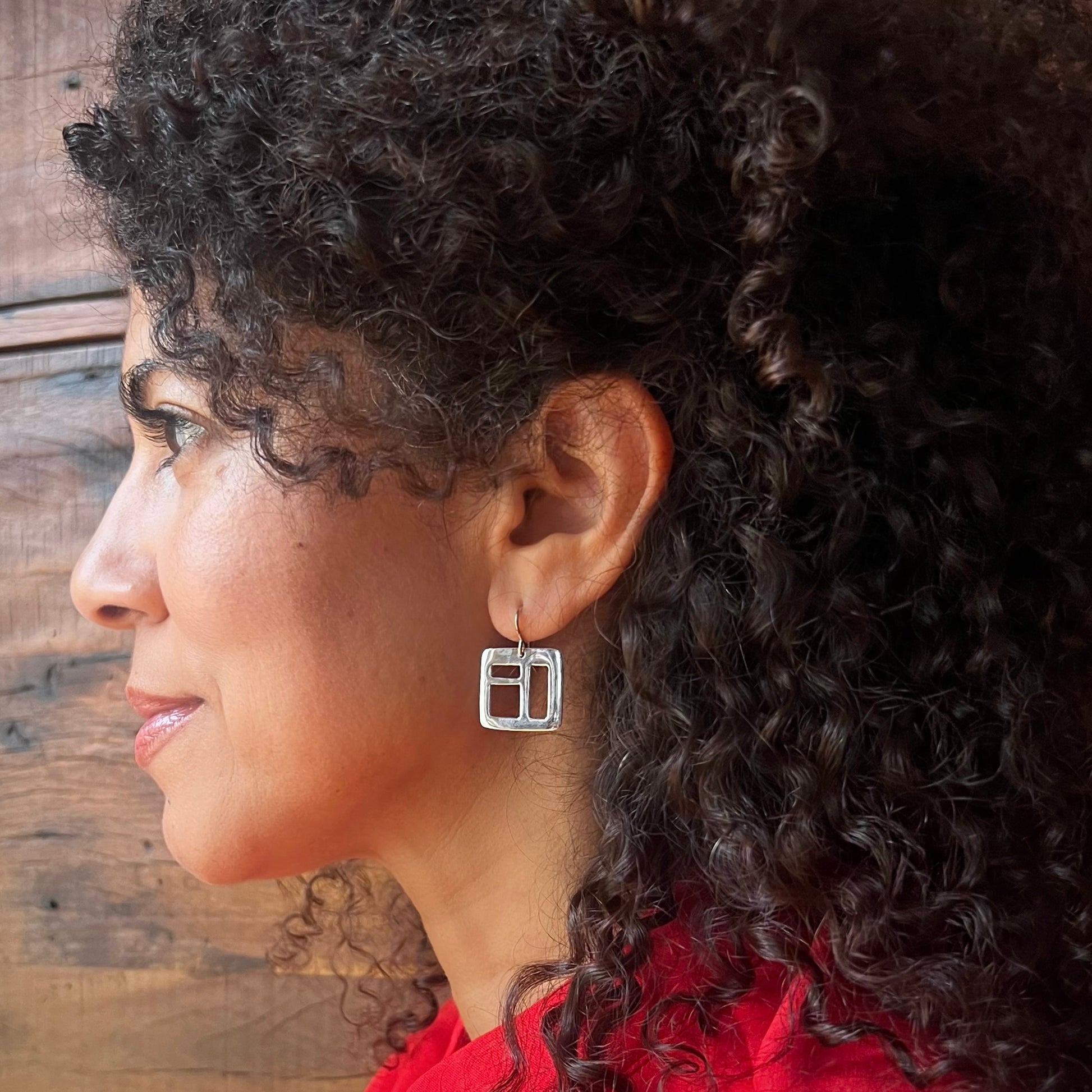 The Windowpane Earrings are delicate, lightweight and striking. Available in sterling silver and brass, each pair is asymmetrical and features small geometric cut-outs. Clean with polishing pad or soft cloth and mild soap. Consciously made in New York.