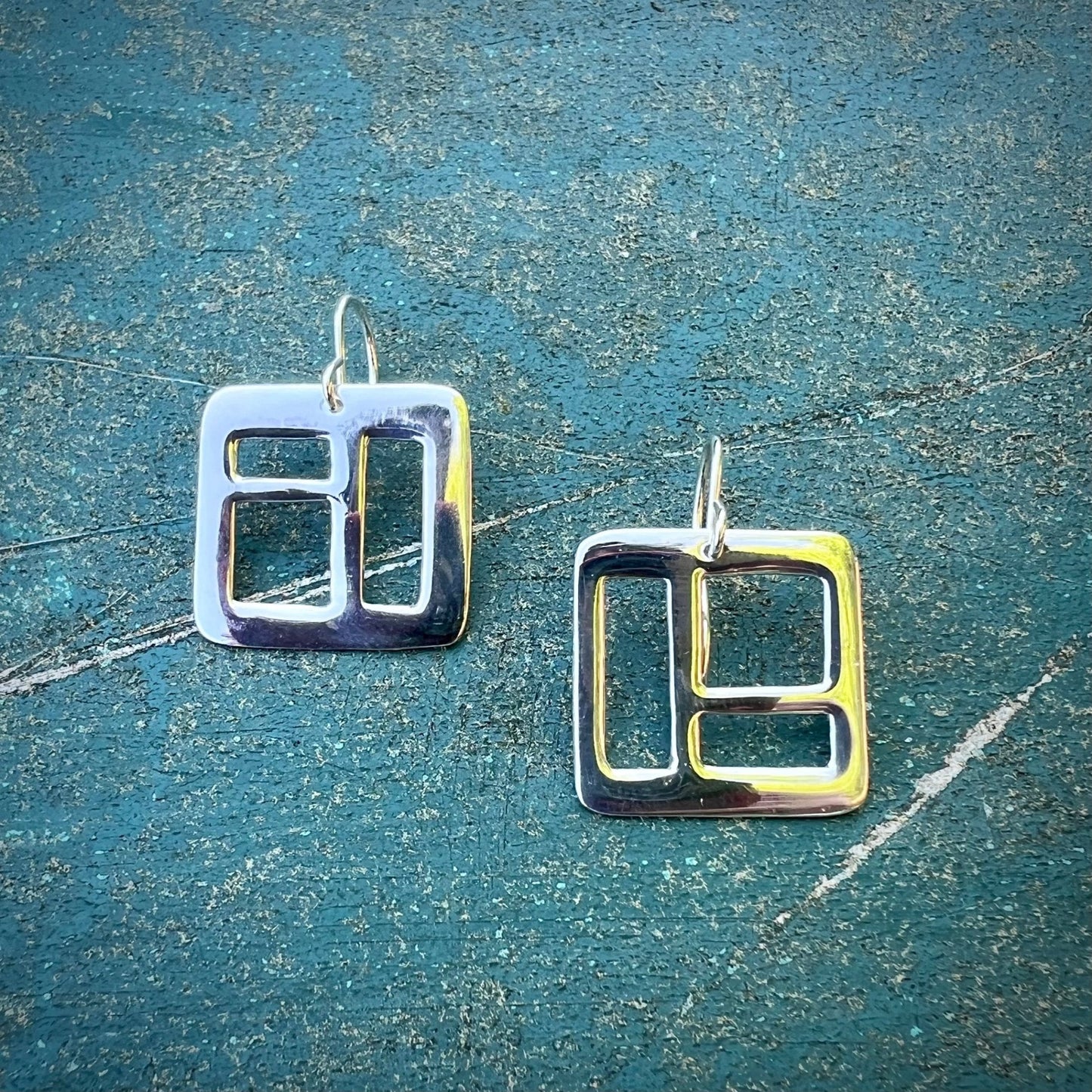 The Windowpane Earrings are delicate, lightweight and striking. Available in sterling silver and brass, each pair is asymmetrical and features small geometric cut-outs. Clean with polishing pad or soft cloth and mild soap. Consciously made in New York.