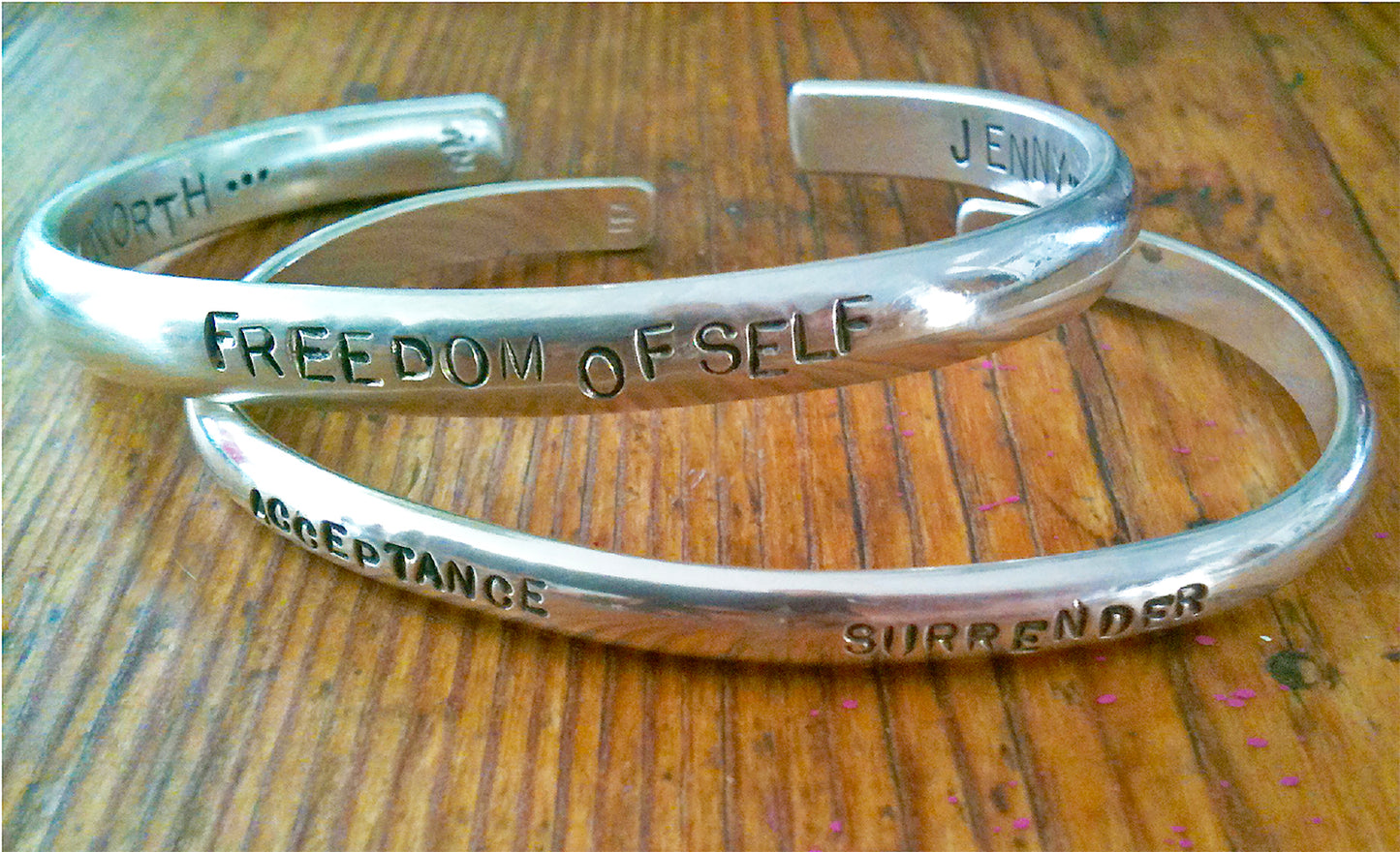 Create your own personalized silver cuff bracelet. Exceptional quality with Randi M.'s beautiful hand stamping technique on a thicker cuff style for a more modern look. Email us your request of what word or words you would like to have on your special keepsake piece, such as inspiring quotes, names of your loved ones, or word affirmations. Both sides of the bracelet can be personalized. Certain shapes, such as hearts, are possible. .25" width, 7" around with 1" opening Made in California